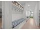 Well-organized mudroom with built-in bench, storage shelves, and access to the backyard at 2821 E Cedar Ave # 17, Denver, CO 80209