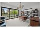 Home office with a modern desk, shelving, and a large window overlooking the backyard at 2821 E Cedar Ave # 17, Denver, CO 80209