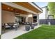 This stylish outdoor patio offers both dining and lounging areas, a fireplace, and a lush green lawn at 2821 E Cedar Ave # 17, Denver, CO 80209