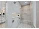 Elegant marble shower with bench, niche, and high-end fixtures at 2821 E Cedar Ave # 17, Denver, CO 80209