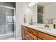 Bathroom featuring a glass-enclosed shower and double sink with plenty of counter space at 888 S Valentia St # 14-103, Denver, CO 80247