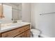 Bathroom with a modern sink, wooden cabinets, tile backsplash, and a shower with glass door at 888 S Valentia St # 14-103, Denver, CO 80247