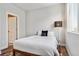 Bedroom features natural light, colorful rug, modern lighting, and a doorway to another room at 888 S Valentia St # 14-103, Denver, CO 80247
