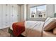 Bedroom featuring an accent wall with cabinets and a view to the outside at 888 S Valentia St # 14-103, Denver, CO 80247