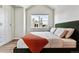 Bedroom featuring built-in wardrobe, a large window and a comfy bed at 888 S Valentia St # 14-103, Denver, CO 80247