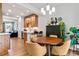 Open concept dinning room with modern light fixture and sliding door to balcony at 888 S Valentia St # 14-103, Denver, CO 80247