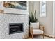 Close up of fireplace with eye catching tile and a modern feel at 888 S Valentia St # 14-103, Denver, CO 80247