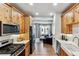 Modern kitchen with stainless steel appliances and seamless transition to living room at 888 S Valentia St # 14-103, Denver, CO 80247