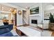 Inviting living room with fireplace and open layout adjacent to the modern kitchen at 888 S Valentia St # 14-103, Denver, CO 80247
