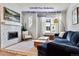 Comfortable living room with fireplace, large television, and lots of natural light at 888 S Valentia St # 14-103, Denver, CO 80247