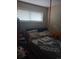 Comfortable bedroom featuring a window and soft bedding for a cozy atmosphere at 6911 Weiman Ct, Commerce City, CO 80022