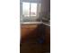Kitchen area with wooden cabinets and dual windows at 6911 Weiman Ct, Commerce City, CO 80022