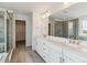 A modern bathroom features a double vanity with quartz countertop at 25254 E Warren Pl, Aurora, CO 80018