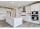 Well-appointed kitchen boasts a center island, white cabinetry, stainless steel appliances, and modern finishes at 25254 E Warren Pl, Aurora, CO 80018