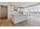 Bright kitchen boasts stainless steel appliances, a large center island, and an open-concept design at 25254 E Warren Pl, Aurora, CO 80018