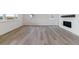 Open-concept living room featuring luxury vinyl plank flooring, a modern fireplace, and neutral color palette at 25254 E Warren Pl, Aurora, CO 80018