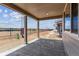 Covered patio with concrete flooring and neutral paint overlooking an iron fence with a nice view at 25254 E Warren Pl, Aurora, CO 80018