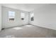 Bright bedroom featuring carpet, white walls and three windows allowing for ample natural light at 4464 Boone Cir, Brighton, CO 80601