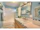Well-lit bathroom with blue walls, classic fixtures, and a tiled vanity at 3835 Pecos St, Denver, CO 80211