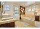 Bright bathroom with tiled floors, modern fixtures, and a separate bathtub at 3835 Pecos St, Denver, CO 80211