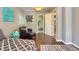 Bedroom with hardwood floors and calming blue walls and an adjacent study area at 3835 Pecos St, Denver, CO 80211