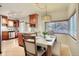 Cozy dining area adjacent to the kitchen, featuring modern lighting and ample seating at 3835 Pecos St, Denver, CO 80211