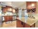 Well-lit kitchen with granite countertops, stainless steel appliances, and wood cabinetry at 3835 Pecos St, Denver, CO 80211