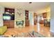 Open-concept living room with hardwood floors, stone fireplace, and built-in shelving at 3835 Pecos St, Denver, CO 80211