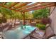 Relaxing outdoor dining area with a glass table, cushioned chairs, and overhead pergola at 3835 Pecos St, Denver, CO 80211