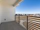 Balcony overlooking the neighborhood with a black metal railing and expansive views at 6153 N Ceylon St # 302, Denver, CO 80249