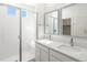 Elegant bathroom featuring double sinks, sleek fixtures, and a spacious glass shower at 6153 N Ceylon St # 302, Denver, CO 80249