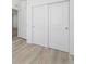 Bedroom with light wood floors and a closet, offering a simple and functional space at 6153 N Ceylon St # 302, Denver, CO 80249