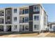 Modern apartment building with multiple balconies and sleek, neutral color scheme at 6153 N Ceylon St # 302, Denver, CO 80249