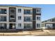 Exterior view of modern townhome building with visible 'For Rent' signage and balconies at 6153 N Ceylon St # 302, Denver, CO 80249