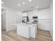 Modern kitchen features stainless steel appliances and a large center island at 6153 N Ceylon St # 302, Denver, CO 80249