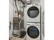 Laundry area with modern washer, dryer, and efficient furnace setup at 6153 N Ceylon St # 302, Denver, CO 80249