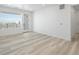 Bright living room with large window and balcony access, neutral paint and flooring at 6153 N Ceylon St # 302, Denver, CO 80249