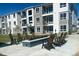 Relaxing outdoor lounge area with comfortable seating surrounding a modern fire pit feature at 6153 N Ceylon St # 302, Denver, CO 80249