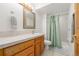 Bathroom featuring a shower-tub combo, single vanity with oak cabinets, and tile flooring at 5048 Rocky Mountain Dr, Castle Rock, CO 80109