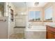 Luxurious bathroom featuring a glass enclosed shower, soaking tub, and a bright window for natural lighting at 5048 Rocky Mountain Dr, Castle Rock, CO 80109