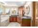 Beautiful bathroom boasts dual sinks, granite countertops, tile flooring, and ample storage in a bright space at 5048 Rocky Mountain Dr, Castle Rock, CO 80109