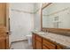 Cozy half bathroom featuring granite countertops, and floral patterned wallpaper at 5048 Rocky Mountain Dr, Castle Rock, CO 80109