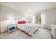 Bright, spacious bedroom with a large window, plush carpeting, and decorative furniture at 5048 Rocky Mountain Dr, Castle Rock, CO 80109