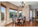 Quaint breakfast nook with brick walls, a round table, and large windows with backyard views at 5048 Rocky Mountain Dr, Castle Rock, CO 80109