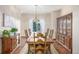 Traditional dining room with wooden table and chairs, chandelier, and a large window at 5048 Rocky Mountain Dr, Castle Rock, CO 80109