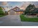 Charming two-story home featuring a stone facade, three-car garage, and landscaped front yard at 5048 Rocky Mountain Dr, Castle Rock, CO 80109