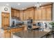 Well-equipped kitchen featuring custom wood cabinets, granite countertops, and stainless steel appliances at 5048 Rocky Mountain Dr, Castle Rock, CO 80109
