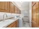 Well-lit laundry room featuring granite countertops, sink, washer, dryer, and oak cabinets at 5048 Rocky Mountain Dr, Castle Rock, CO 80109