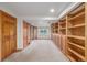 Finished basement features an entertainment area, built-in shelving and storage, and neutral paint at 5048 Rocky Mountain Dr, Castle Rock, CO 80109