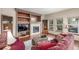Cozy living room with a fireplace, built-in shelves, comfortable seating, and natural light at 5048 Rocky Mountain Dr, Castle Rock, CO 80109